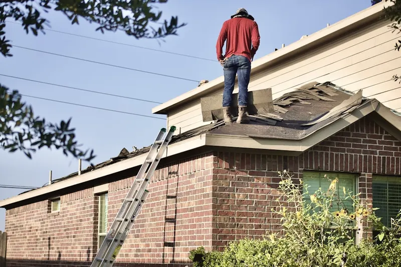 Professional roofer working on a residential roof in Oysterville